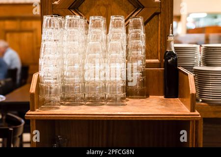 Stacks of clean empty glasses in a restaurant Stock Photo