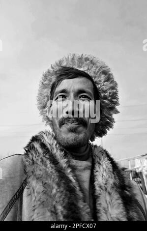 Portrait of an Uyghur man wearing a winter jacket. Picture taken at a weekly market in the outskirts of Kashgar, Xinjiang, China. Stock Photo