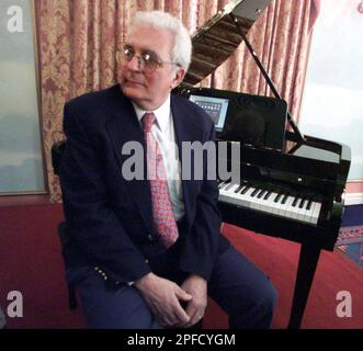 Dr. Robert Moog, inventor of the Synthesizer, sits next to a Van