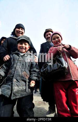 An Uyghur family visiting a local market in the outskirts of Kashgar, Xinjiang, China. Stock Photo