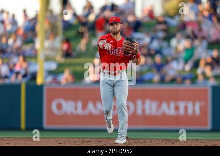 MARCH 16, 2023, Lakeland FL USA; Philadelphia Phillies infielder Jim Haley fields and throws to first bace during an MLB spring training game against Stock Photo