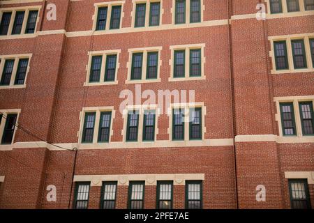 Urban brick buildings lining a city street, showcasing classic architecture, textured brick facades, and modern city atmosphere. Ideal for architectur Stock Photo