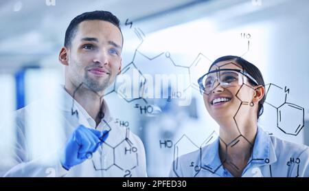 With each strand, the code becomes clearer. two young scientists working on a glass wipe board in their lab. Stock Photo