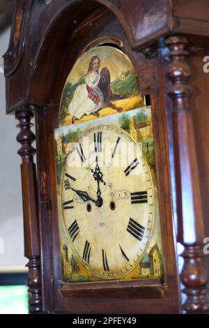 Painted face of an old wooden clock Stock Photo