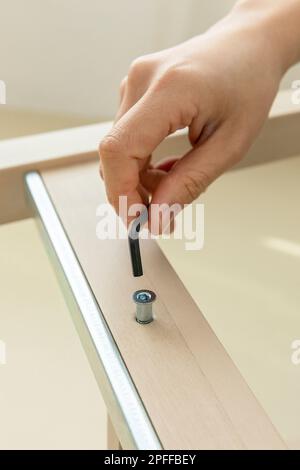 DIY interior hand motion, closeup assemble furniture Stock Photo