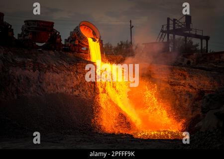 Discharge of metallurgical slag from blast furnaces. Beautiful stream of hot slag Stock Photo