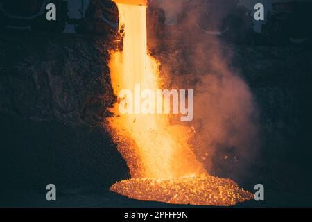 Discharge of metallurgical slag from blast furnaces. Beautiful stream of hot slag Stock Photo