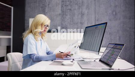Account Manager In Office Coding Medical Bill Stock Photo