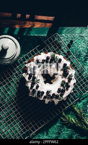 Berry pound cake on a green background. Stock Photo