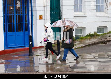 Hastings, East Sussex, UK. 17 Mar, 2023. UK Weather: Heavy rain expected throughout the day at the seaside town of Hastings in East Sussex. A woman holds an umbrella to shield from the rainy weather. Photographer: Paul Lawrenson, Photo Credit: PAL News /Alamy Live News Stock Photo