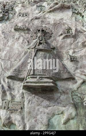 Bronze plaque in front of the Monastery of Saint Mary of Guadalupe depicting the black Madonna and her son Jesus, Our Lady of Guadalupe.Spain. Stock Photo