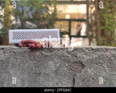 Close up of open single cardboard match box on granite stone background, Box filled with tiny match sticks Stock Photo
