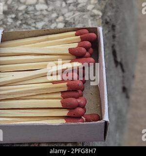 Close up of open single cardboard match box on granite stone background, Box filled with tiny match sticks Stock Photo