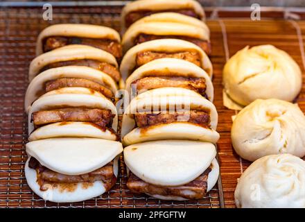Traditional Pork chop bun on the stall in Macau. Chinese street food. Stock Photo