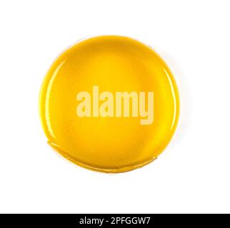 Close-up of round yellow medical lozenges for sore throat with honey tast isolated on white, top view Stock Photo