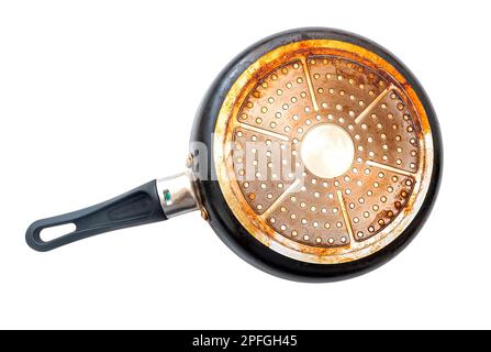 Bottom of an old used dirty frying pan isolated on white, top view Stock Photo
