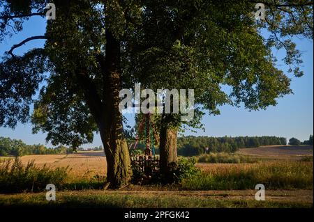 Roadside cross between the doors in the fields Stock Photo