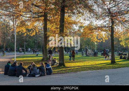 Young people enjoy the beautiful autumn weather in the Vondelpark in Amsterdam. Stock Photo