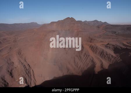 Trucks loading iron ore at the SNIM open-pit iron ore mine. Zouerat, Mauritania. Stock Photo