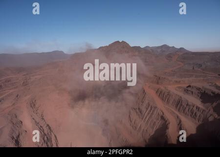 Trucks loading iron ore at the SNIM open-pit iron ore mine. Zouerat, Mauritania. Stock Photo