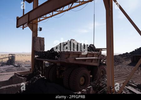 Trucks loading iron ore at the SNIM open-pit iron ore mine. Zouerat, Mauritania. Stock Photo