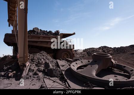 Trucks loading iron ore at the SNIM open-pit iron ore mine. Zouerat, Mauritania. Stock Photo