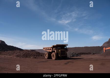 Trucks loading iron ore at the SNIM open-pit iron ore mine. Zouerat, Mauritania. Stock Photo