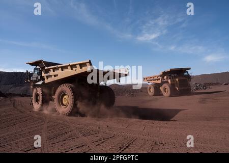 Trucks loading iron ore at the SNIM open-pit iron ore mine. Zouerat, Mauritania. Stock Photo