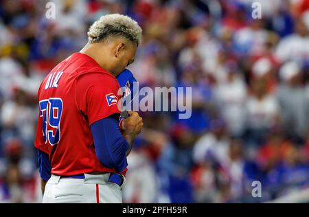 Puerto Rico pitcher Edwin Diaz (39) is being helped by team pitching coach  Ricky Bones and medical staff after the the Pool D game against Dominican  Republic at the World Baseball Classic