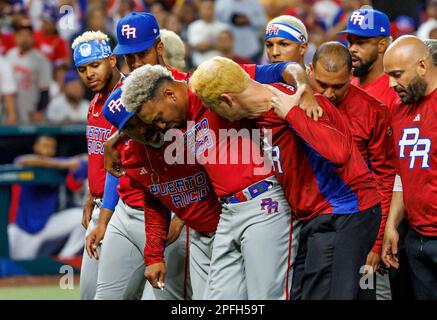 Puerto Rico pitcher Edwin Diaz (39) is being helped by team pitching coach  Ricky Bones and medical staff after the the Pool D game against Dominican  Republic at the World Baseball Classic