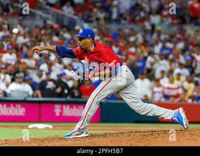 Puerto Rico pitcher Edwin Diaz (39) is being helped by team pitching coach  Ricky Bones and medical staff after the the Pool D game against Dominican  Republic at the World Baseball Classic