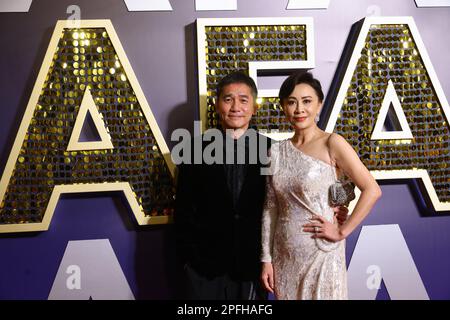 Actor Tony Leung Chin-wai (left) and his wife Carina Lau Ka-ling (right) pose at the red carpet at the 16th Asian Film Awards at Hong Kong Palace Museum, in Hong Kong.   12MAR23.   SCMP / Dickson Lee Stock Photo