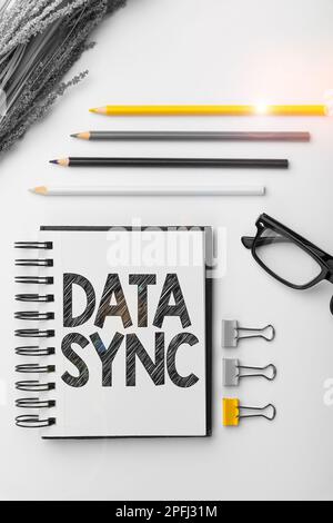 Writing displaying text Data Sync. Word Written on data that is continuously generated by different sources Stock Photo