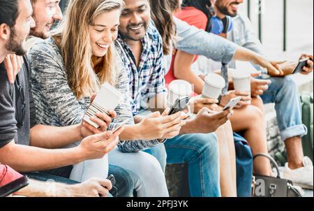 Multicultural people group using smartphone with coffee at university college campus - Gen z hands addicted by mobile smart phone - Technology concept Stock Photo