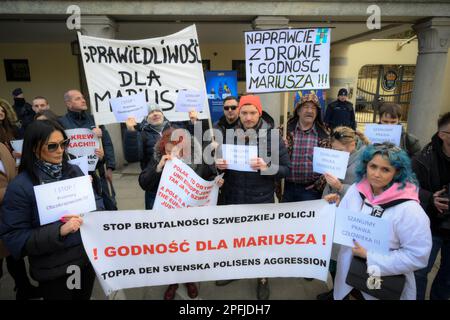 Family and supporters are seen rallying in front of the Swedish embassy in Warsaw, Poland on 17 March, 2023. Mariusz Dworakowski, a 47 year old Polish man arrested in December 2021 by Sweidsh police is currently serving time in jail in Sweden. Family membes say Mariusz was in the wrong place at the wrong time and was forced to remain lying on the street in freezing cold temperatures after suffering physical abuse by police. His family is demanding financial compensation for permanent injuries suffered during the arrest. Swedish authorities deny any wrongdoing by police and say the Mariusz will Stock Photo