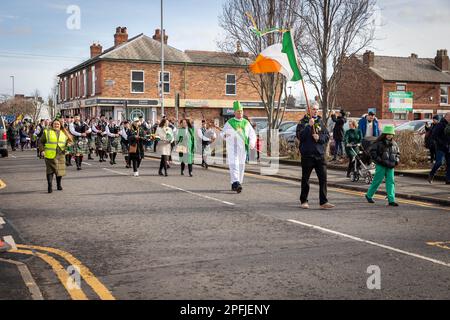 2023 St Patrick’s Day Parade in Orford Lane Warrington. The Irish Flag leads the procession Stock Photo