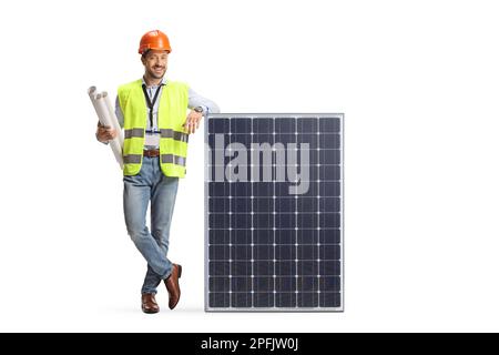 Engineer with blueprints leaning on a solar panel isolated on white background Stock Photo