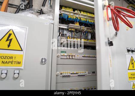 Open electrical distribution box in a modern office building. Stock Photo