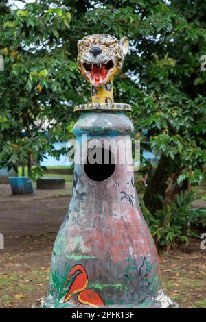 Tortuguero, Costa Rica - A trash can (basuero) decorated with a jaguar's head in a small village on the Caribbean coast. Jaguars live in nearby Tortug Stock Photo