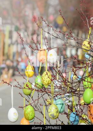 view of twigs with decorative Easter eggs on blurred background Stock Photo
