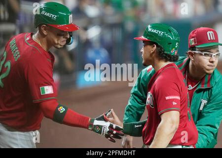 Mexico center fielder Alek Thomas (5), right, is congratulated after  scoring a run on a hit by Alex Verdugo (27) in the fifth inning of a World  Baseball Classic game against Puerto