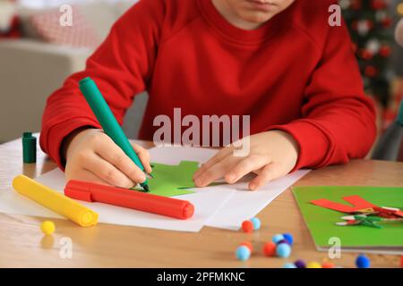 Close up of a baby toddler drawing a picture by left hand using colored  markers. Left handed child. Stock Photo by buregina