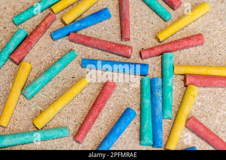 Multicolor chalks on a cork board Stock Photo