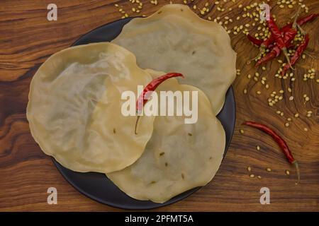 Papad, Khichiya papad, Rice papad, Chawal papad isolated on wooden background. Stock Photo