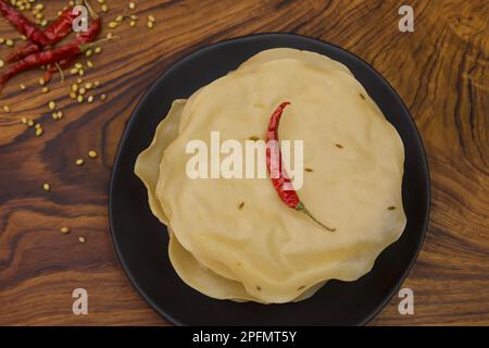 Papad, Khichiya papad, Rice papad, Chawal papad isolated on wooden background. Stock Photo