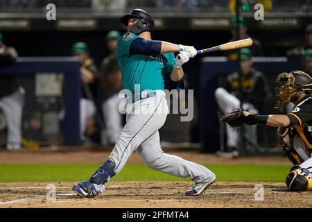 Seattle Mariners' Ty France, left, hits a two-run home run against the San  Diego Padres during the fourth inning of a spring training baseball game,  Friday, March 17, 2023, in Peoria, Ariz. (