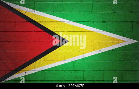 Flag of Guyana painted on a cinder block wall. Stock Photo