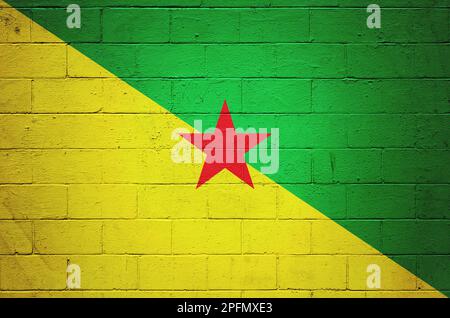 Flag of French Guyana painted on a cinder block wall. Stock Photo