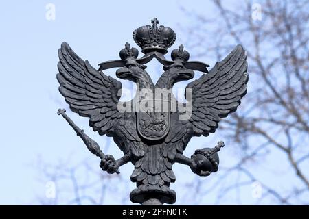 KRONSTADT, RUSSIA - MARCH 13, 2023: The old skullpture of the two-headed eagle is the coat of arms of the Russian Empire. Fragment of the design of th Stock Photo