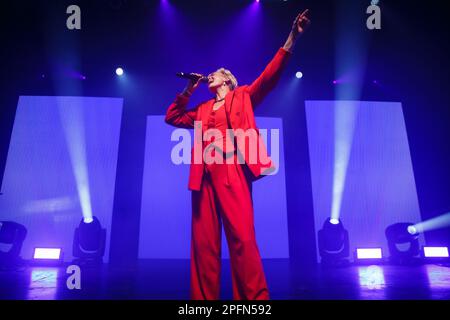 Toronto, Canada. 17th Mar, 2023. Australian-American singer Betty Who performs on stage in a red suit holding a microphone Credit: Bobby Singh/Alamy Live News Stock Photo